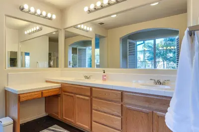 a bathroom with two sinks and two mirrors at Near Wineries and Parks Waterfront Tracy Getaway! in Tracy