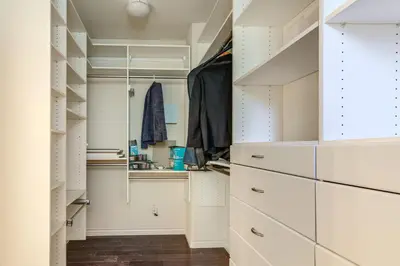 a walk in closet with white cabinets at Near Wineries and Parks Waterfront Tracy Getaway! in Tracy