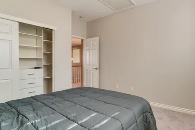 a bedroom with a bed and a closet at Near Wineries and Parks Waterfront Tracy Getaway! in Tracy