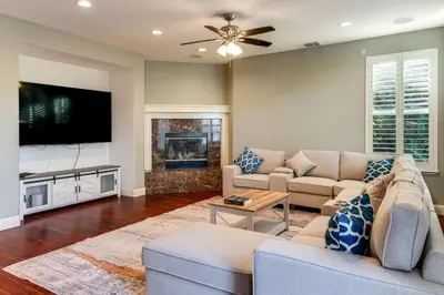 a living room with a couch and a tv at Near Wineries and Parks Waterfront Tracy Getaway! in Tracy