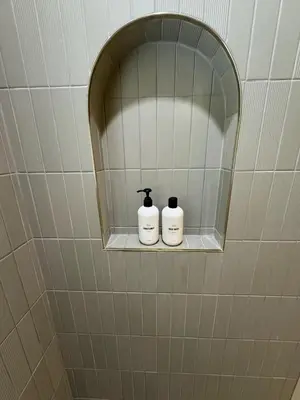 two bottles of soap sitting on a shelf in a bathroom at Quiet retreat - Hot tub & sauna in Three Rivers in Three Rivers