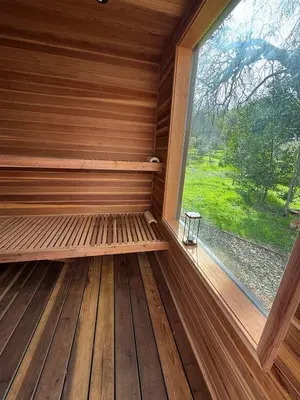 a sauna with a window in a wooden cabin at Quiet retreat - Hot tub & sauna in Three Rivers in Three Rivers
