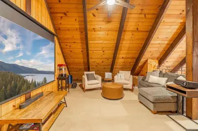 a large living room with a view of a lake at Cozy Tahoma Family Cabin in the Pines Sleeps 6 Pets in Tahoma