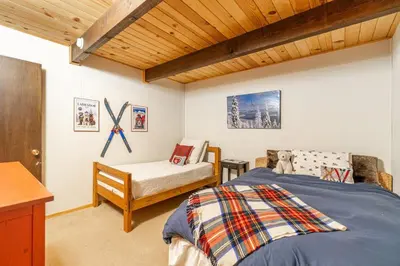 a bedroom with a bed and a chair in it at Cozy Tahoma Family Cabin in the Pines Sleeps 6 Pets in Tahoma