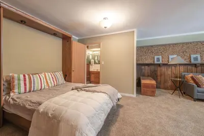 a bedroom with a large bed in a room at Chamberland retreat-Hot Tub, Pool Table, Movie & Ski in Homewood