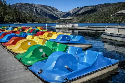 a bunch of boats are docked at a dock at Strawberry Chalet Near Pinecrest & Dodge Ridge in Strawberry