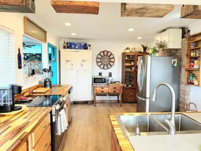 a kitchen with a sink and a refrigerator at Hot Tub, Farm Chic Shingle Springs Birders Heaven in Shingle Springs