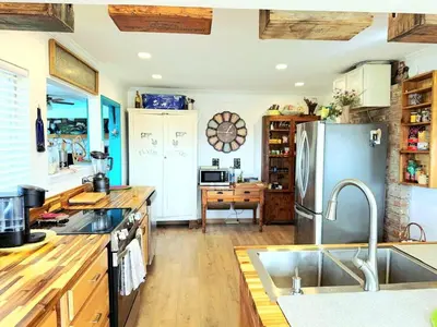 a kitchen with a sink and a refrigerator at Hot Tub, Farm Chic Shingle Springs Birders Heaven in Shingle Springs
