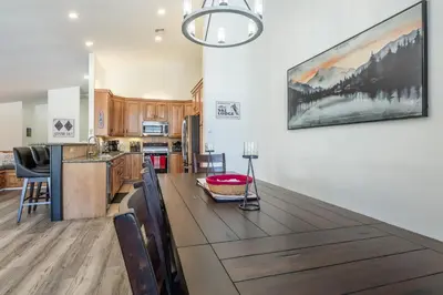 a kitchen and dining room with a large wooden table at Snowcreek 704 in Mammoth Lakes