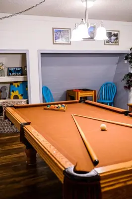 a pool table in a room with blue chairs at Red Barn Haven-Your romantic getaway to Yosemite in Oakhurst