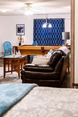 a living room with a pool table and a couch at Red Barn Haven-Your romantic getaway to Yosemite in Oakhurst