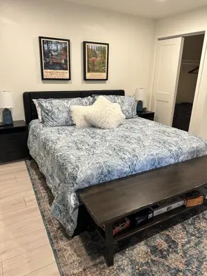 a bedroom with a large bed with a table at Hidden Gem House incredible location remodeled in South Lake Tahoe
