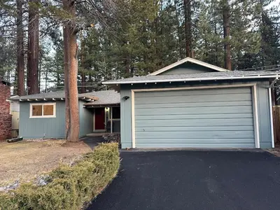 a house with a garage and a driveway at Hidden Gem House incredible location remodeled in South Lake Tahoe