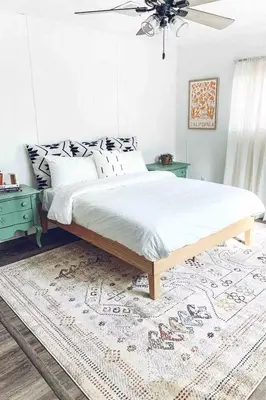 a bedroom with a large bed and a rug at Yosemite Boho Bungalow, Pet Friendly & Mtn Views! in Coarsegold