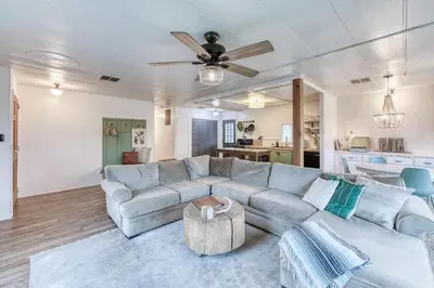 a living room with a couch and a ceiling fan at Yosemite Boho Bungalow, Pet Friendly & Mtn Views! in Coarsegold
