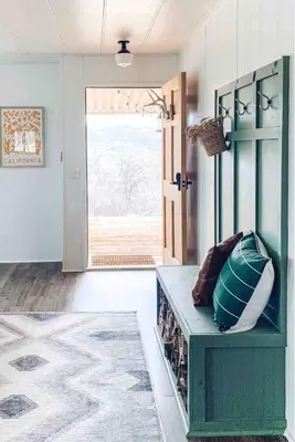 a living room with a green bench and a door at Yosemite Boho Bungalow, Pet Friendly & Mtn Views! in Coarsegold