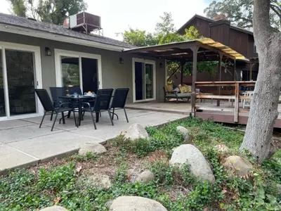 a patio with a table and chairs on a house at River Retreat near Sequoia National Park in Three Rivers