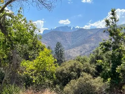 a view of a mountain with trees and mountains at River Retreat near Sequoia National Park in Three Rivers