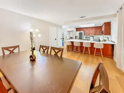 a dining room and kitchen with a table and chairs at Spacious 4BR Family Home Free Parking, Fast WiFi, Near Galleria & Fountains in Roseville