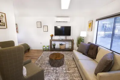 a living room with a couch and a tv at Fox Cabin - Lakefront - Sleeps 4 in Bass Lake