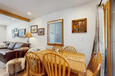 a dining room with a table and chairs and a couch at Aspen Pines Chalet in South Lake Tahoe