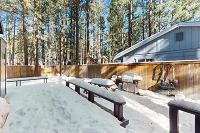 a group of benches in the snow next to a fence at Aspen Pines Chalet in South Lake Tahoe