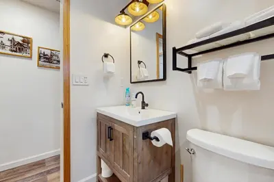 a bathroom with a sink and a toilet and a mirror at Aspen Pines Chalet in South Lake Tahoe