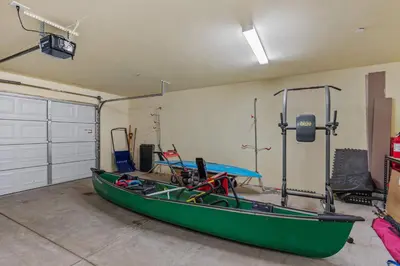 a green boat in a room with a garage at Mountain Retreat - Sleeps 7 - Canoe - Fireplace in Soda Springs