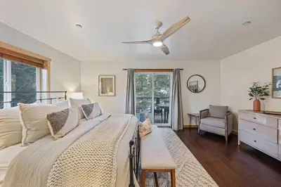 a bedroom with a bed with a ceiling fan at Mountain Retreat - Sleeps 7 - Canoe - Fireplace in Soda Springs