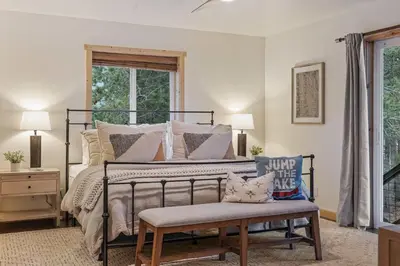 a bedroom with a bed with pillows and a bench at Mountain Retreat - Sleeps 7 - Canoe - Fireplace in Soda Springs