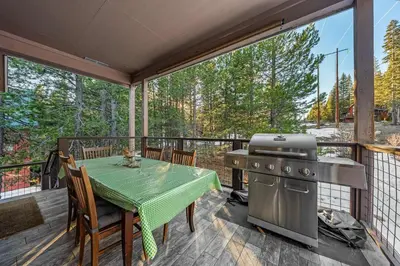 a patio with a table and a grill on a deck at Mountain Retreat - Sleeps 7 - Canoe - Fireplace in Soda Springs