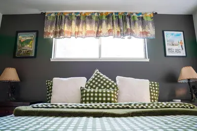 a bedroom with a bed with pillows and a window at Sierra Cabin w NEW Hot Tub Walk to Town in Twain Harte