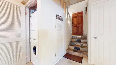 a white laundry room with a washer and dryer at Timberline #08 condo in Mammoth Lakes