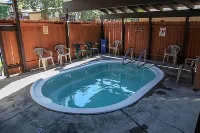 a jacuzzi tub with chairs and a fence at Timberline #08 condo in Mammoth Lakes