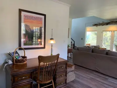 a living room with a desk and a couch at Sunset Cottage near Yosemite in Oakhurst