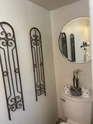 a bathroom with a toilet and a mirror at Sunset Cottage near Yosemite in Oakhurst
