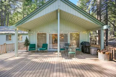 a covered deck with chairs and a grill at Modern Cabin Escape wGame Room, Huge Deck, WIFI in Arnold