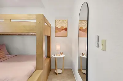 a bedroom with two bunk beds and a mirror at Modern Cabin Escape wGame Room, Huge Deck, WIFI in Arnold