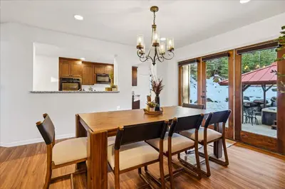 a kitchen and dining room with a wooden table and chairs at Yosemite Spirit in White Wolf