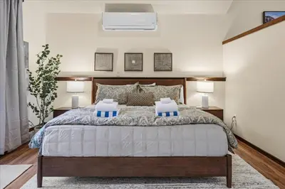 a bedroom with a large bed and two lamps at Yosemite Spirit in White Wolf