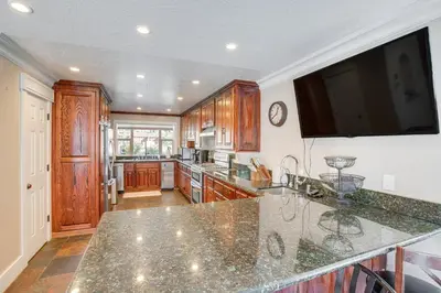 a kitchen with wooden cabinets and a large counter top at Beach and Skiing at Zephyr Cove house in Zephyr Cove
