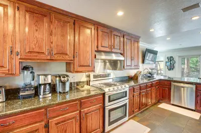 a large kitchen with wooden cabinets and appliances at Beach and Skiing at Zephyr Cove house in Zephyr Cove