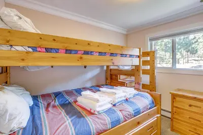 a bedroom with two bunk beds and a window at Beach and Skiing at Zephyr Cove house in Zephyr Cove