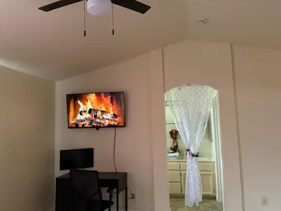a living room with a ceiling fan and a mirror at Vineyard inspired house in stockton in Stockton