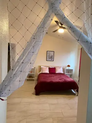 a bedroom with a bed with a stone wall at Vineyard inspired house in stockton in Stockton
