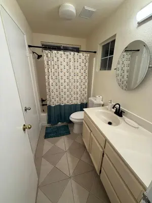 a bathroom with a sink and a toilet and a mirror at Vineyard inspired house in stockton in Stockton