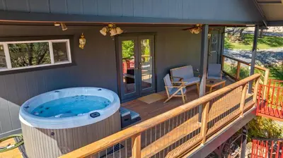 a hot tub on the deck of a house at Cozy Lake View 4Bd 2,5Br Retreat in 5 Acres, Hot Tub and more in Auburn