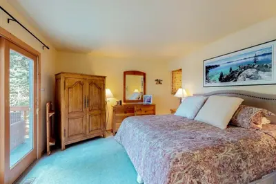 a bedroom with a bed and a large window at Lakeview Luxury Getaway in South Lake Tahoe