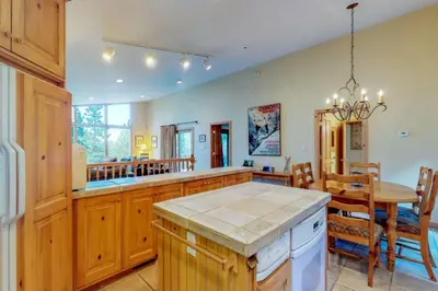 a kitchen with a table and a dining room at Lakeview Luxury Getaway in South Lake Tahoe