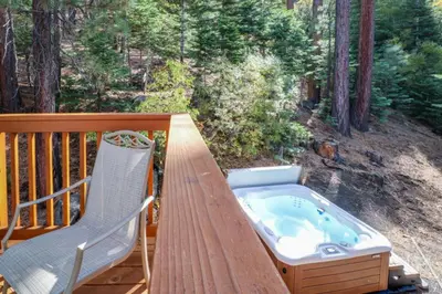 a hot tub sitting on a deck with a chair at Lakeview Luxury Getaway in South Lake Tahoe